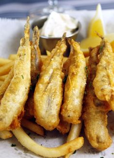 fried fish and french fries with lemon wedges