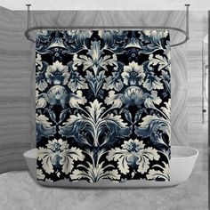 a black and white shower curtain with blue flowers on it in front of a bathtub