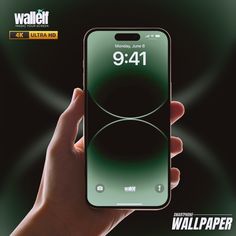 a hand holding an iphone with the wallpaper logo on it