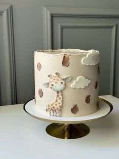 a giraffe cake sitting on top of a white table