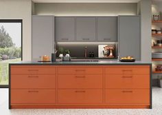 an orange and grey kitchen with lots of counter space