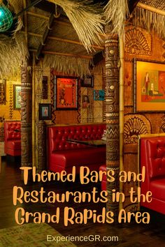 the interior of a restaurant with red couches and tiki huts on the walls