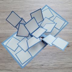 several pieces of cut out paper sitting on top of a wooden table