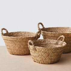 three woven baskets sitting on top of a table