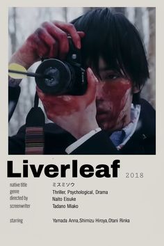 a man holding a camera taking a photo with blood on his face and the words liver