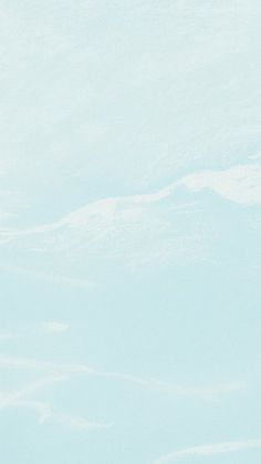 a man riding skis down the side of a snow covered slope on top of a snowboard