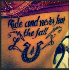 a woman's back with the words ride and never fall on her side tattoo