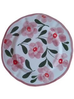 a white plate with pink flowers painted on it