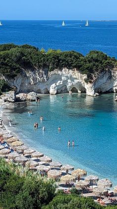 people are swimming in the clear blue water