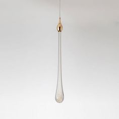 a white and gold pendant hanging from a ceiling