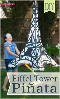 the eiffel tower pinata is made out of paper and has a woman standing next to it