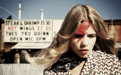 a woman with her hair blowing in the wind