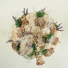 a bridal bouquet made up of flowers and pine cones