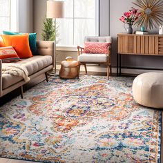 a living room filled with furniture and a large rug on top of a wooden floor