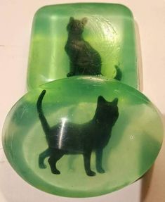 a black cat sitting on top of a green object