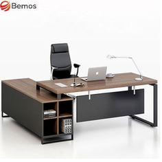 an office desk with a laptop on it and a book shelf underneath the desk,