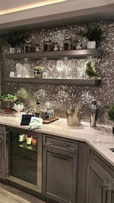 a kitchen with stainless steel cabinets and white marble counter tops is pictured in this image