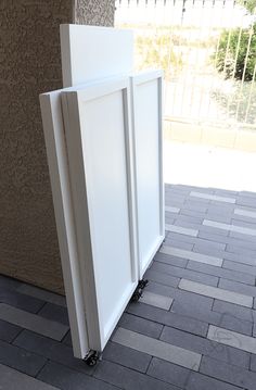 a white cabinet sitting on the side of a building