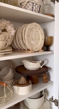 the shelves are filled with dishes and plates