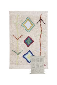 a white rug with various colored squares and lines on the front, along with an advert