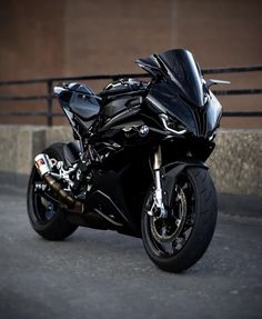 a black motorcycle parked in front of a building