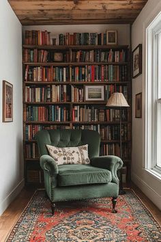 a green chair sitting in front of a book shelf filled with books