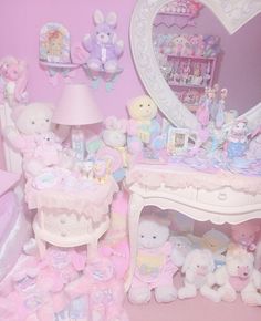 a room filled with lots of stuffed animals next to a dresser and mirror on the wall