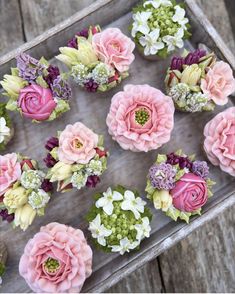 pink and white flowers are arranged on a tray