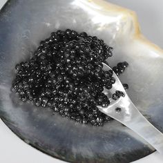 a spoon with some black beads in it