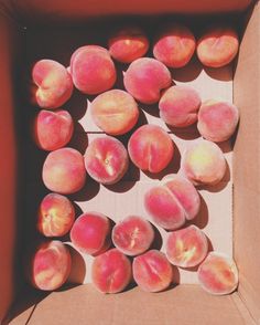 a box filled with peaches sitting on top of a table