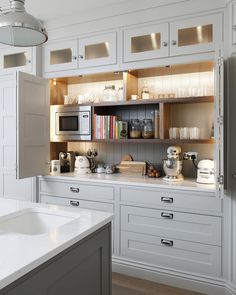 a kitchen with white cabinets and lots of counter space