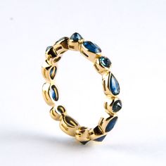 "Beautiful blue sapphire eternity ring in 14K solid gold. Round, pear and oval sapphires are set upside down which allows the pavillion facets to create beautiful sparkles. The shank is designed with small windows under bezels to get more light which shows the color of the stone better. As this is an eternity ring it will be made to your ring size. So please allow us max 15 working days for shipment. Generally we need to change the stone shape placements to achieve the requested ring size which Sapphire Rose Gold Ring, Sapphire Anniversary Ring, Stone Ring Design, Memory Ring, Sapphire Eternity Band, Sapphire Eternity Ring, Small Windows, Ring Ideas, September Birthstone