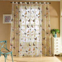 curtains with butterflies on them are hanging in front of a white dresser and blue chair