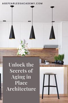 an open kitchen with white cabinets and black pendant lights above the bar area is featured in this article