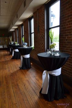 tables with black and white linens are lined up