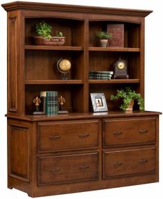 a wooden bookcase with drawers and plants on top