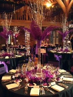 the tables are decorated with purple and silver decorations