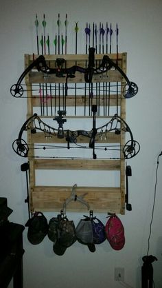 a wall mounted archery rack with many arrows