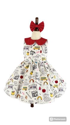 The perfect dress for back to school. Dress is made from back to school items print cotton fabric.  Handmade with love💕 Includes 1 dress and a red coordinating hair bow.  * Placement : Each dress is custom made so the pattern placement will vary for each dress. Making each dress unique.  Dresses are 100% made by me in my pet free smoke free house. Dress is crafted using 100% cotton fabric and is serged and lined for a professional finish. This dress is pictured with a petticoat to show details. If you would like the fullness and puffiness like the picture please select the style with petticoat option. Please refer to sizing guide to make sure you are purchasing the correct size for your little girl. This dress is made to order. It will take me about 1-2 weeks to make and then ship out, bu Playful Cotton Dresses For School, Playful Fitted Dress For School, White Cotton School Dress, Sleeveless Cotton School Dress, White Cotton Dresses For School, Cute School Dress For Spring, Multicolor Summer Dress For School, Cute Spring Dress For School, Multicolor Cotton School Dress