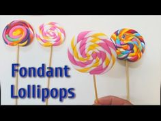 colorful lollipops are being held by someone's hand with the words fondant lollipops