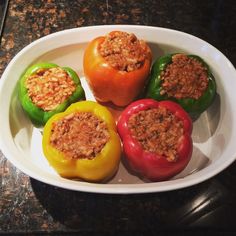 four peppers with meat toppings on a white plate