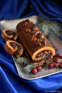 there is a piece of cake on the plate with berries and nuts next to it