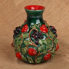 Enchanted by Mother Nature's beauty, this ceramic vase spreads vines of passion around your ambiance. Directly from the Armenian region, Ruben and Arpine's sylvan-themed creation surrounds classic pomegranate details with leaves—painted by hand and enriched by a glazed finish. Pomegranate Ceramic, Hades Cabin, Ceramic Bud Vase, Ear Cuff Jewelry, Curated Gift Boxes, Ceramics Projects, Green Ceramics, Bud Vase, Home Decor Store