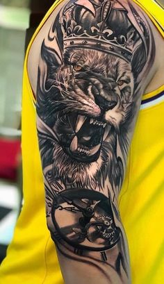 a man with a lion and crown tattoo on his arm