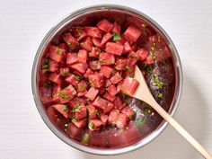 watermelon and parsley in a pot with a wooden spoon