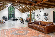 a garage with leather couches and bicycles on the wall