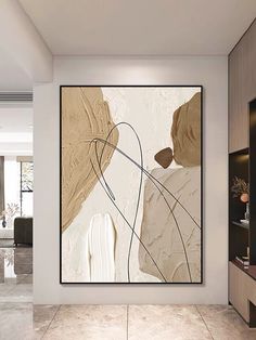 an abstract painting hangs on the wall in a modern living room with tile flooring