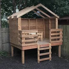 a small wooden structure sitting in the middle of a yard