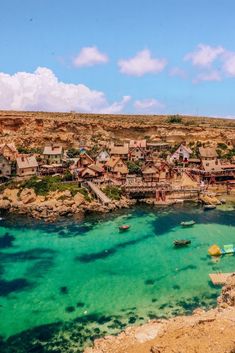 the water is crystal blue and clear with boats in it's waterside area