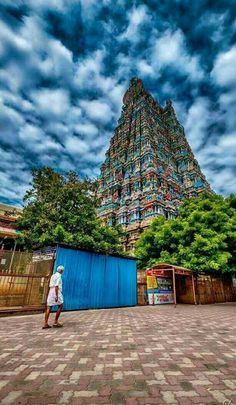 a man standing in front of a tall building